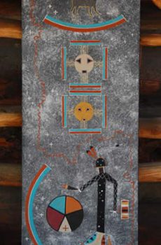 A vertical painting featuring Native American symbolic art, with figures and celestial motifs on a textured gray background, displayed against a wooden surface.