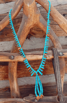 Natural Lone Mtn Turquoise & Shell Tab necklace draped over a rustic wooden chair with visible pegs and grain.