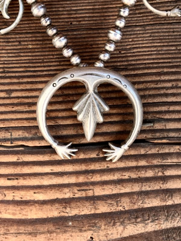 A silver necklace with an eagle on it