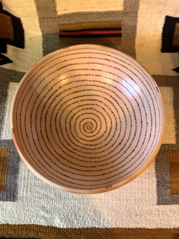 A bowl with a spiral design on it.