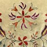 A close up of the fabric with flowers and leaves