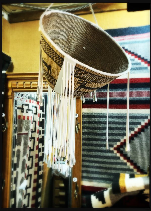 A close up of a basket hanging from the ceiling