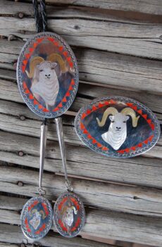 A set of three rams head dishes hanging on the wall.