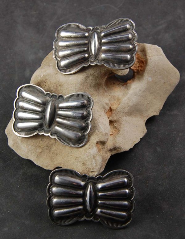 A group of three silver bow tie shaped rings.