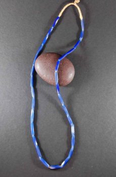 A blue string is wrapped around a rock.