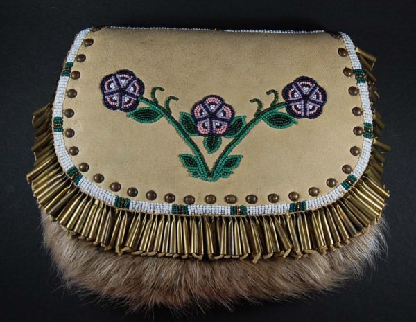 A purse with fur and flowers on it.