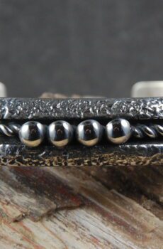 A close up of the side of a silver bracelet