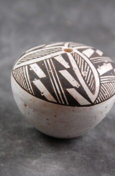 A small ceramic bowl with black and white designs.