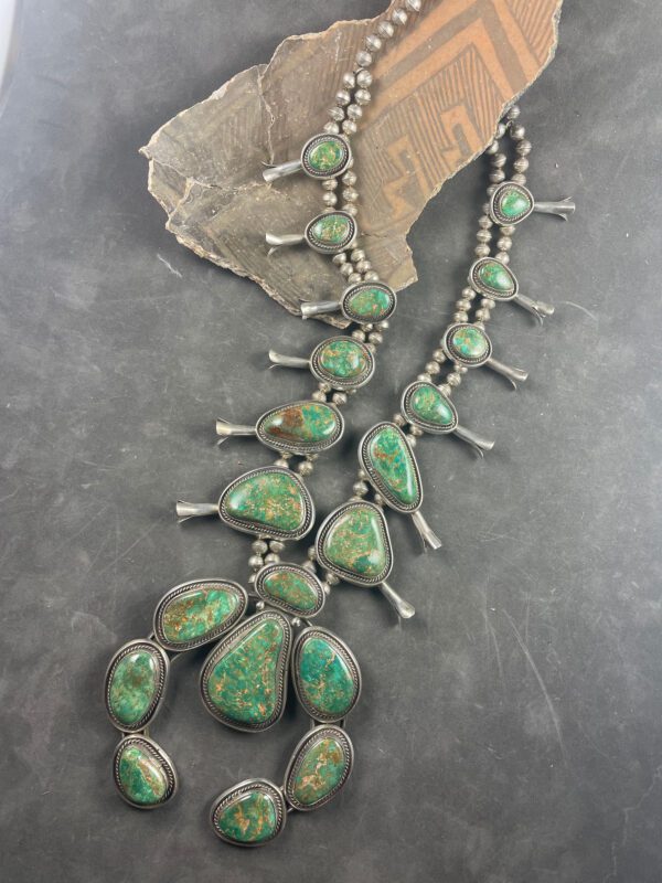 A necklace with green stones on it