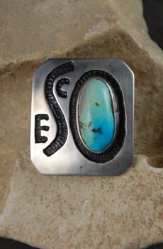 A silver ring with a blue stone on top of it.