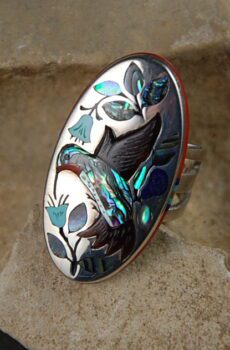 A ring with an image of a hummingbird on it.