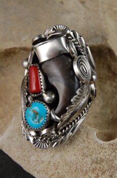 A silver ring with turquoise and red coral.