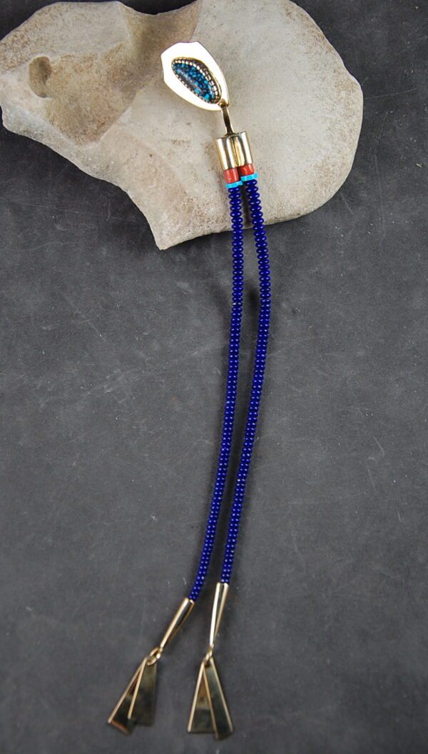 A blue bead necklace with red and white beads.