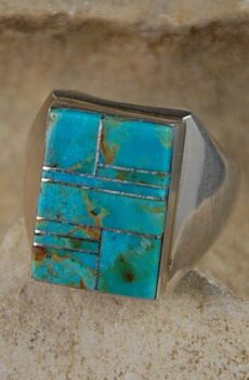 A turquoise ring is shown on the rock.