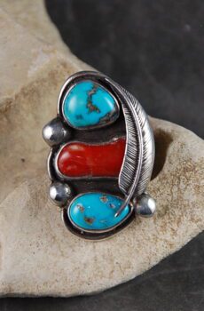 A ring with three different colored stones on it.