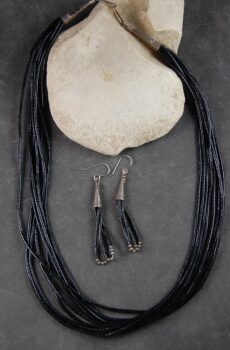 A necklace and earrings set of black leather.