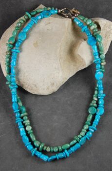A necklace of turquoise and green jasper beads.