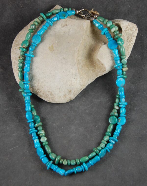 A necklace of turquoise and green jasper beads.