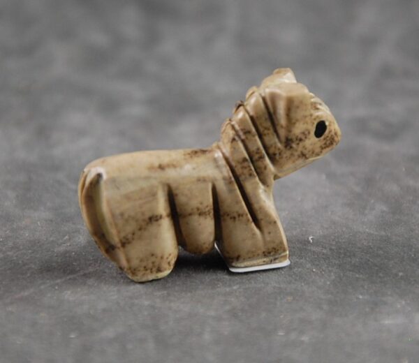 A small ceramic animal sitting on top of a table.