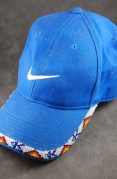 A blue nike hat with a white swoosh on it.