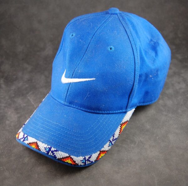 A blue nike hat with a white swoosh on it.