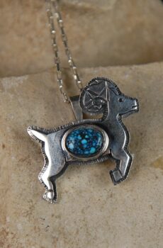 A silver dog with blue stone on it's back.