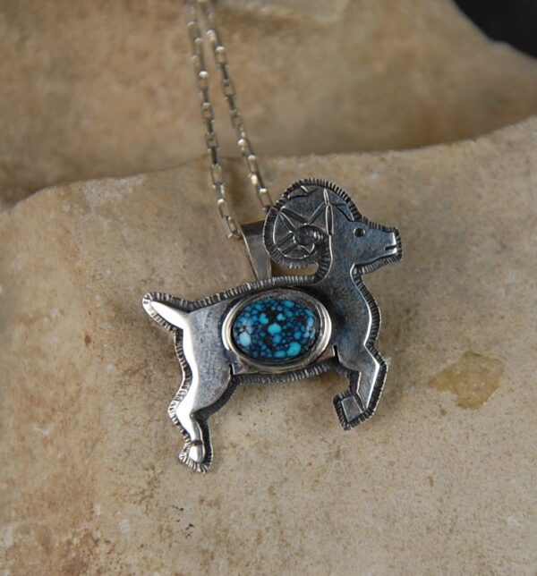A silver dog with blue stone on it's back.