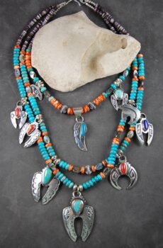 A necklace with feathers and beads on it