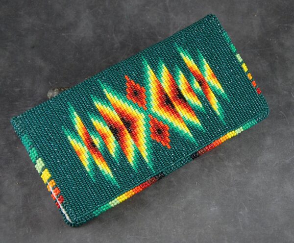 A green wallet with red, yellow and orange designs.