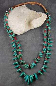 A long necklace of turquoise and red coral.