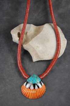 A necklace with an orange and turquoise bead.