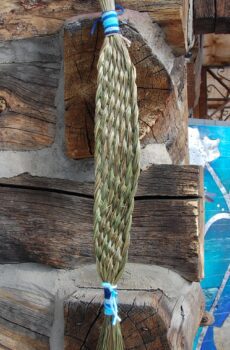 A long green braid hanging on the side of a wall.