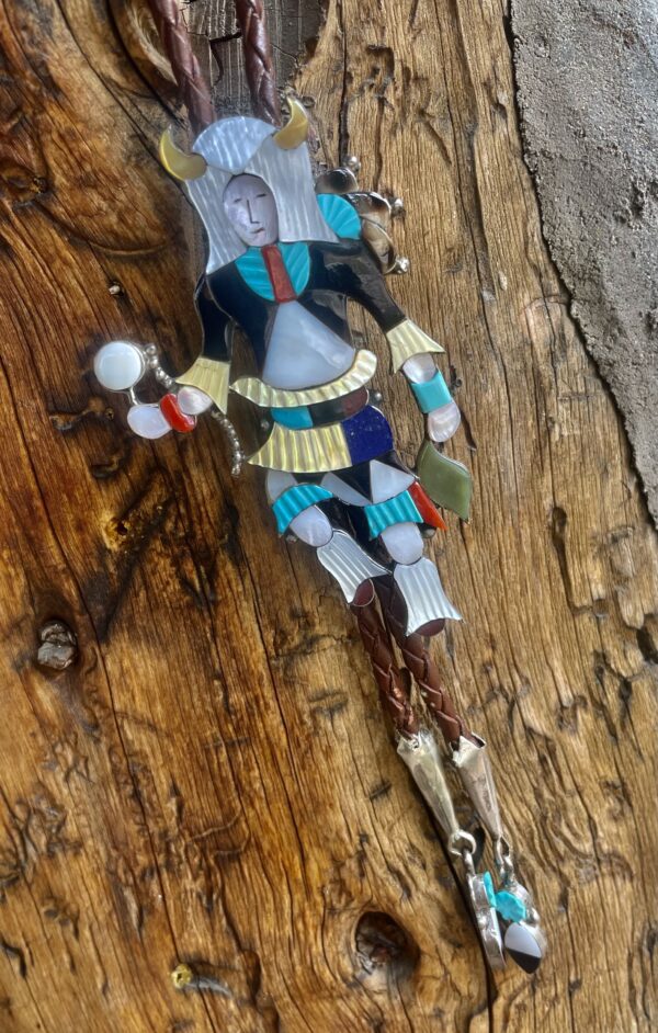 A wooden wall with a toy of a knight holding a sword.