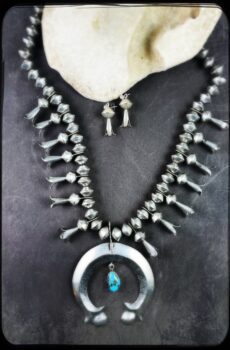 A necklace and earrings set with turquoise.